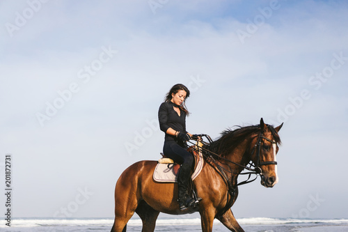 low angle view of young female equestrian sitting on horse © LIGHTFIELD STUDIOS