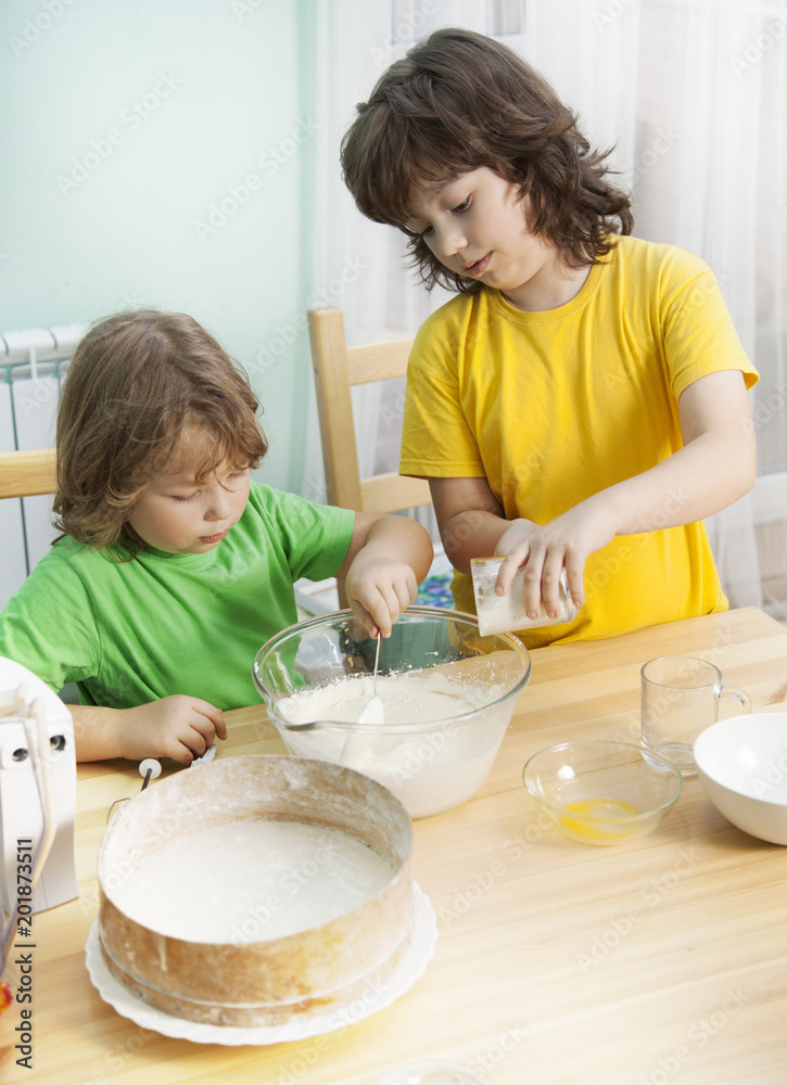 happy family funny kids are preparing the dough, bake cookies in the kitchen happy family funny kids are preparing the dough, bake cookies in the kitchen