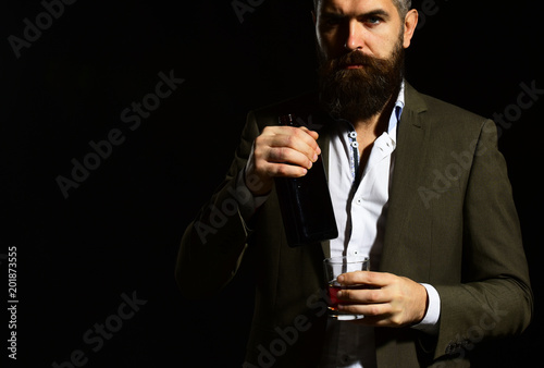 Businessman with serious face in suit on black background