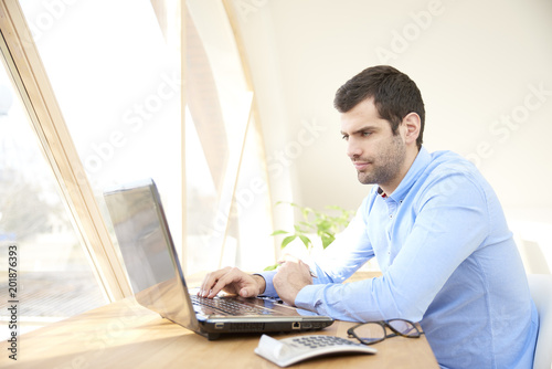 Young businessman working on laptop