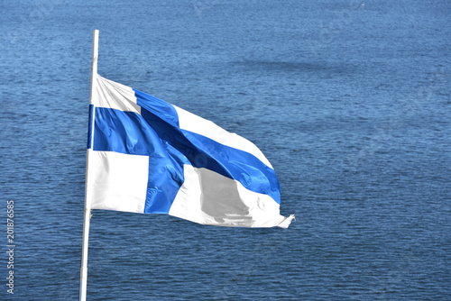 National flag of Finland against background of sea