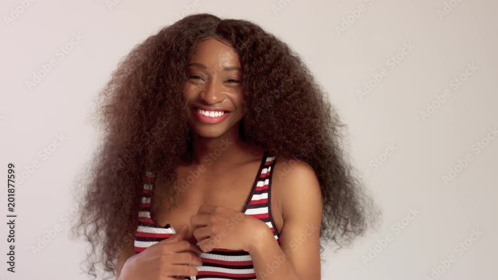 Beauty black mixed race african american woman with long curly hair and perfect smile looking at camera and smiling on white Beauty black mixed race african american woman with long curly hair and perfect smile looking at camera and smiling on white