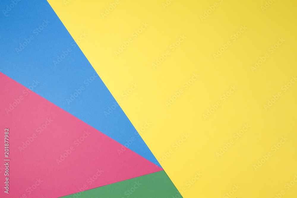 Color papers geometry flat composition background with yellow, green, red and blue tones Color papers geometry flat composition background with yellow, green, red and blue tones