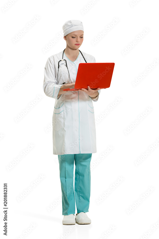 Beautiful young woman in white coat posing at studio. Full length studio shot isolated on white. Beautiful young woman in white coat posing at studio. Full length studio shot isolated on white.