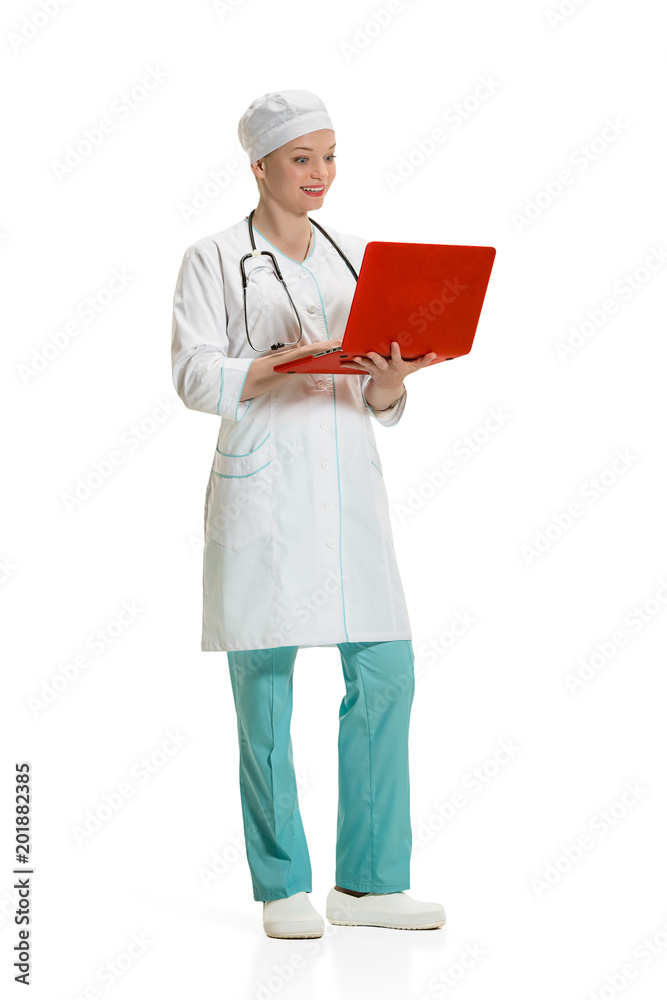 Beautiful young woman in white coat posing at studio. Full length studio shot isolated on white. Beautiful young woman in white coat posing at studio. Full length studio shot isolated on white.