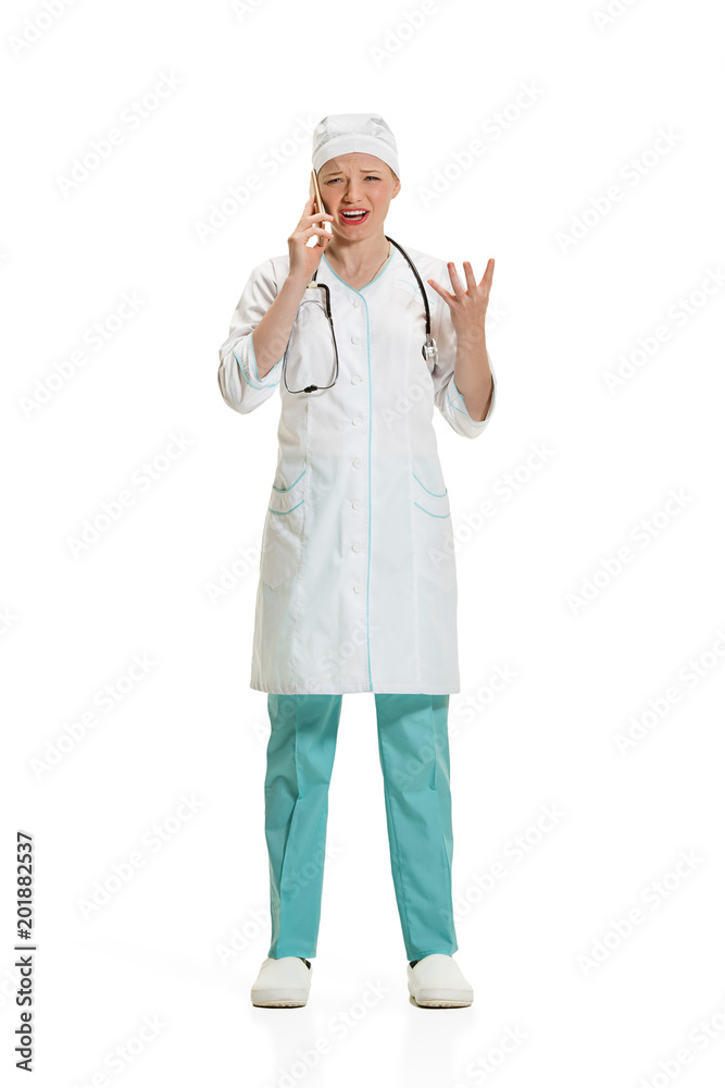 Beautiful young woman in white coat posing at studio. Full length studio shot isolated on white.