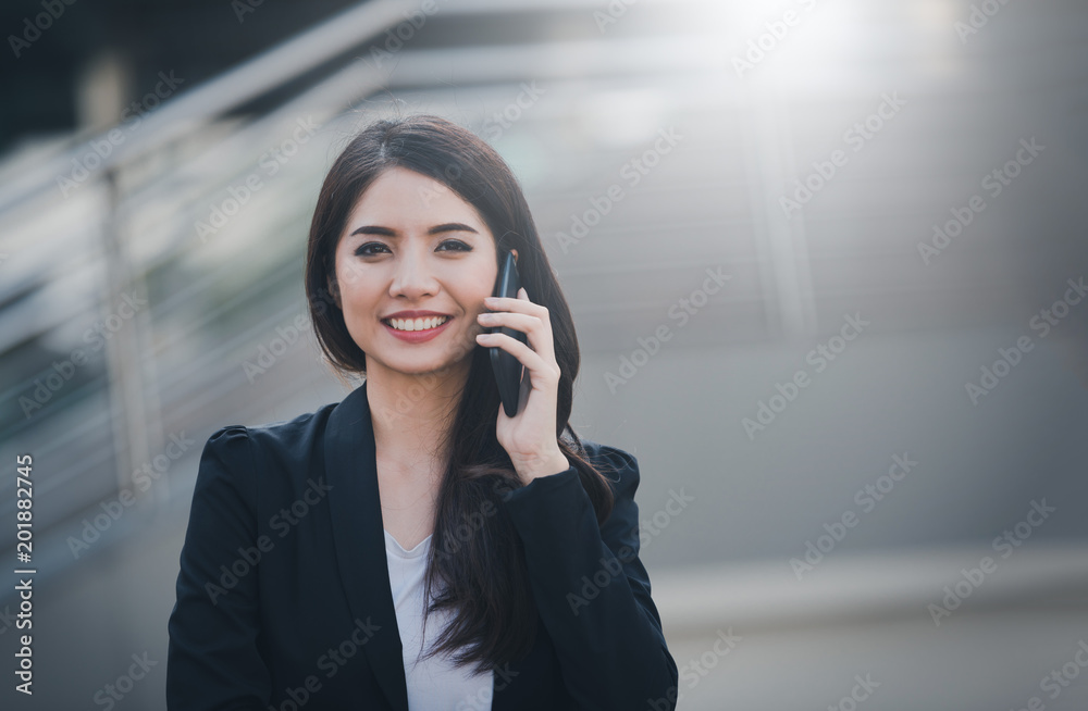 Portrait of business woman happy smile talking on smartphone with blurred background. Business concept. Vintange tone Portrait of business woman happy smile talking on smartphone with blurred background. Business concept. Vintange tone
