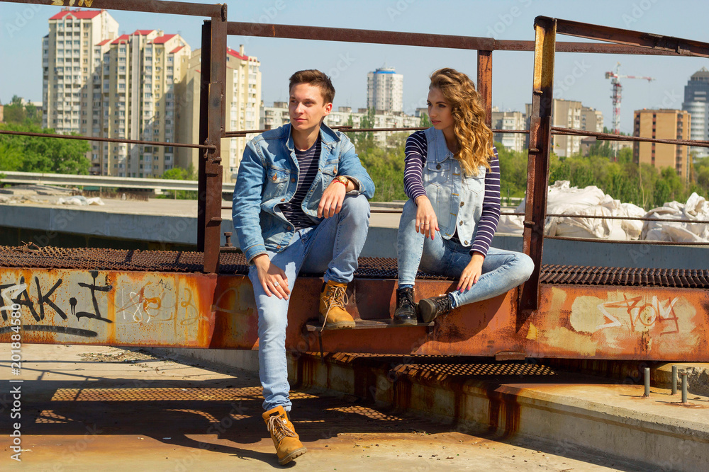 Young beautiful fashion couple wearing jeans clothes in daylight. Love concept. Young beautiful fashion couple wearing jeans clothes in daylight. Love concept.