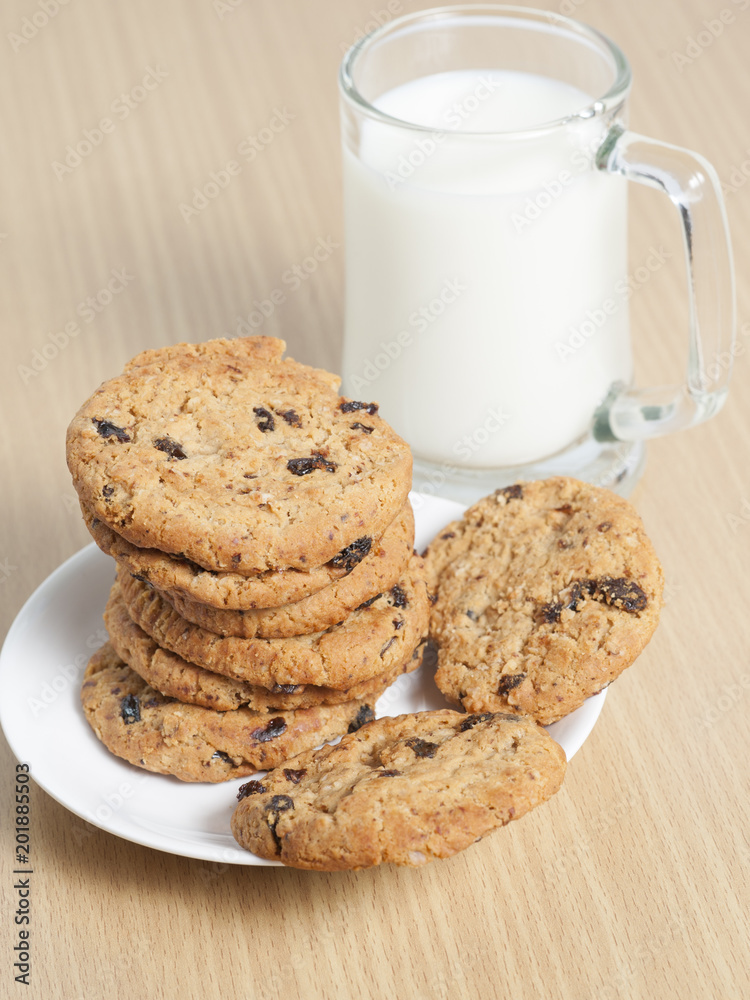 Chocolate chip cookies with milk on wooden table Chocolate chip cookies with milk on wooden table
