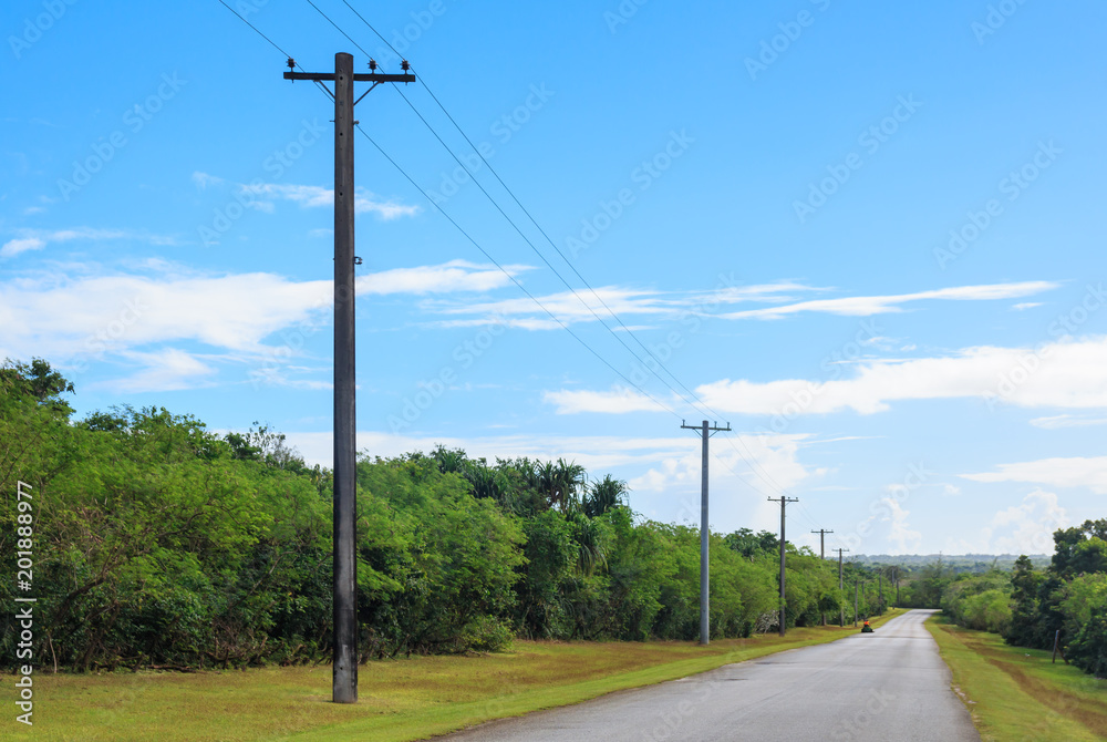 Straight road to horizon with utility pole