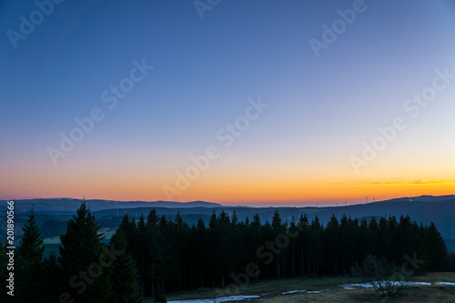 Germany, Nature forest landscape from above at sunset with orange color sky