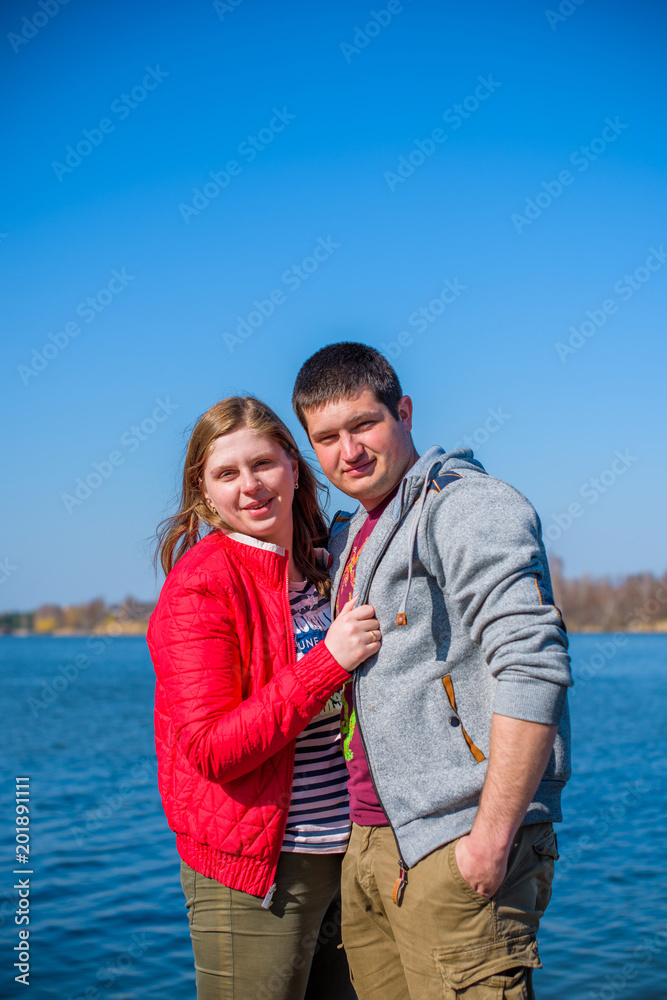 American young couple with overweight walk in park, man and woman together American young couple with overweight walk in park, man and woman together
