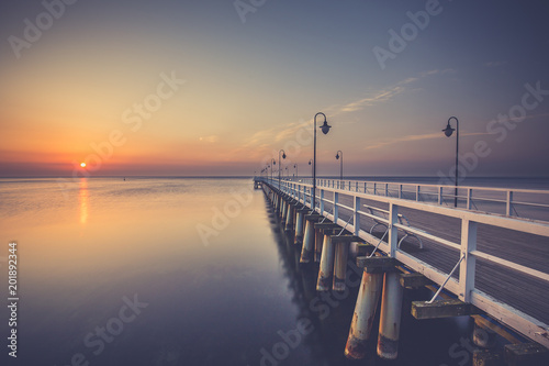 Amazing colorful sunrise over the pier in Gdynia Orlowo. Sunrise over the sea.