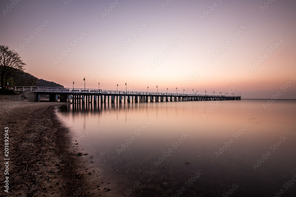 Amazing colorful sunrise over the pier in Gdynia Orlowo. Sunrise over the sea.