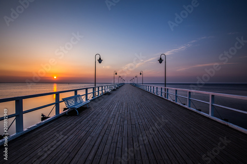 Obraz na płótnie Amazing colorful sunrise over the pier in Gdynia Orlowo. Sunrise over the sea. w salonie