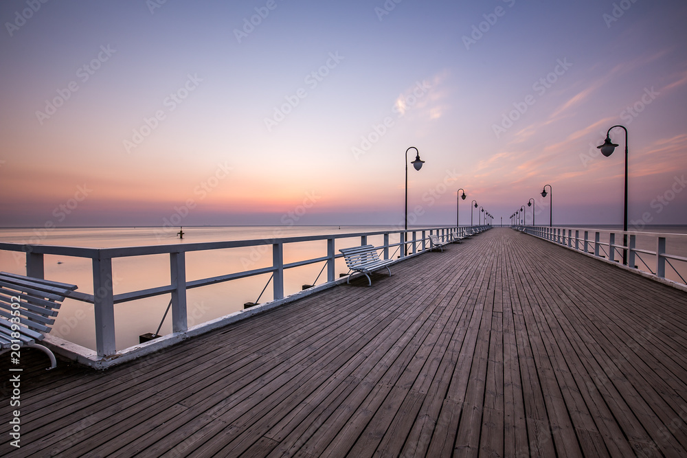 Amazing colorful sunrise over the pier in Gdynia Orlowo. Sunrise over the sea.