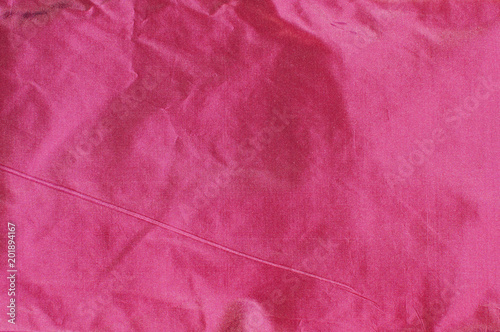 Magenta color taffeta silk fabric closeup as textile background