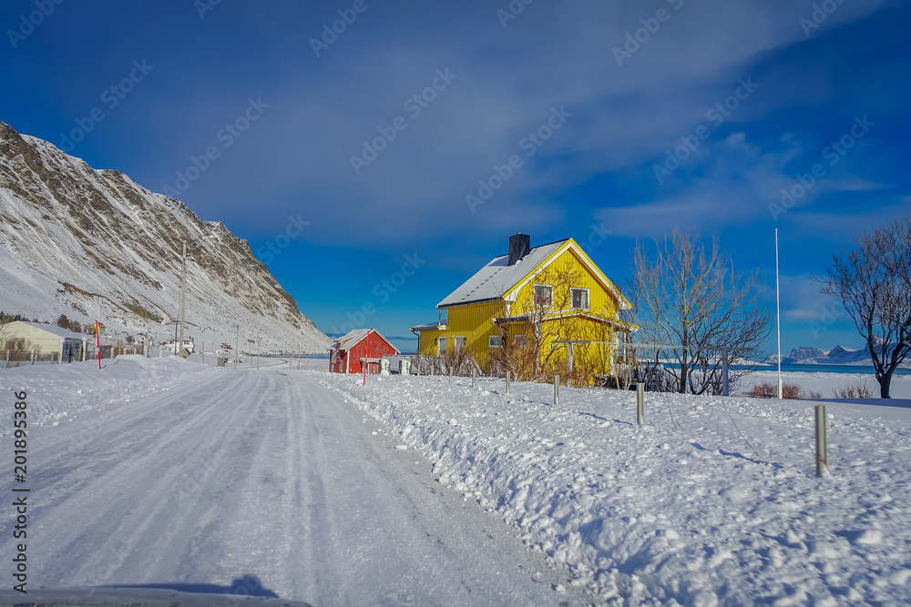Outdoor view of wooden houses partial covered with snow in Lofoten islands Outdoor view of wooden houses partial covered with snow in Lofoten islands