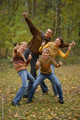 Happy smiling family in autumn forest 