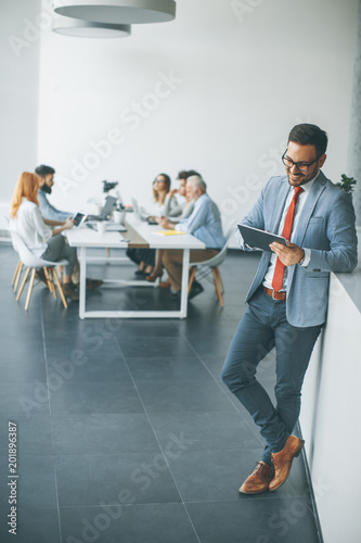 Young businessman with digital tablet in office