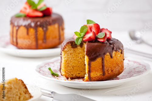 Small Vanilla And Strawberries Cakes With Chocolate Topping