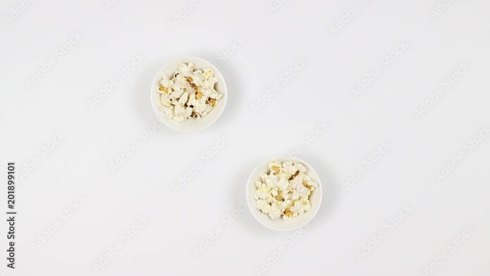 A couple drinks beer and eats popcorn. Woman and a man. Top view. Fast shooting. A couple drinks beer and eats popcorn. Woman and a man. Top view. Fast shooting.