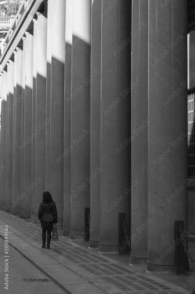 Woman walking close to colonnade