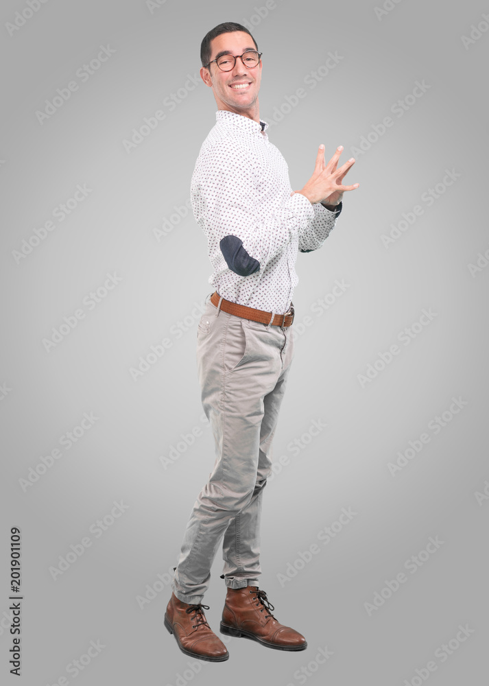 Confident young man with a gesture of concentration and teamwork - Full body shot Confident young man with a gesture of concentration and teamwork - Full body shot