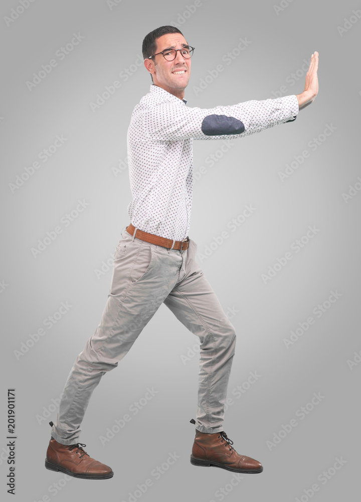 Concerned young man with a gesture of hold - Full body shot Concerned young man with a gesture of hold - Full body shot