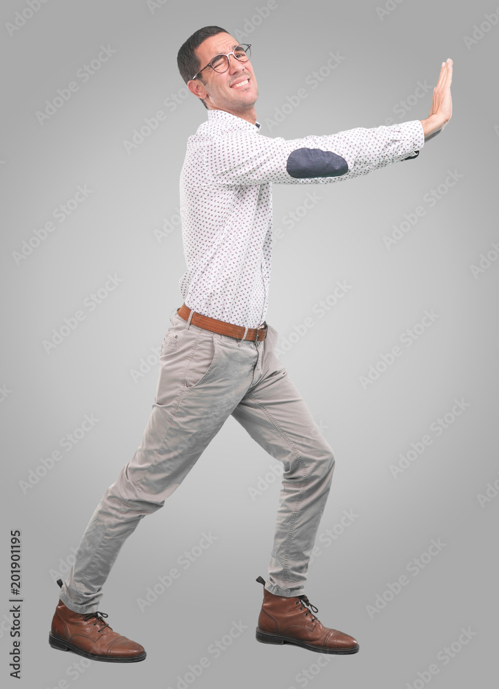 Concerned young man with a gesture of hold - Full body shot Concerned young man with a gesture of hold - Full body shot