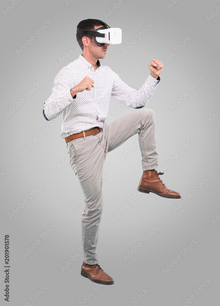 Young man using a virtual reality glasses - Full body shot Young man using a virtual reality glasses - Full body shot