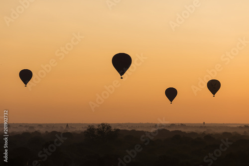 Balloon silhouette with sunrise over the ancient temples in Bagan, Myanmar