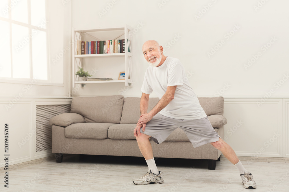 Senior man warmup stretching training indoors Senior man warmup stretching training indoors
