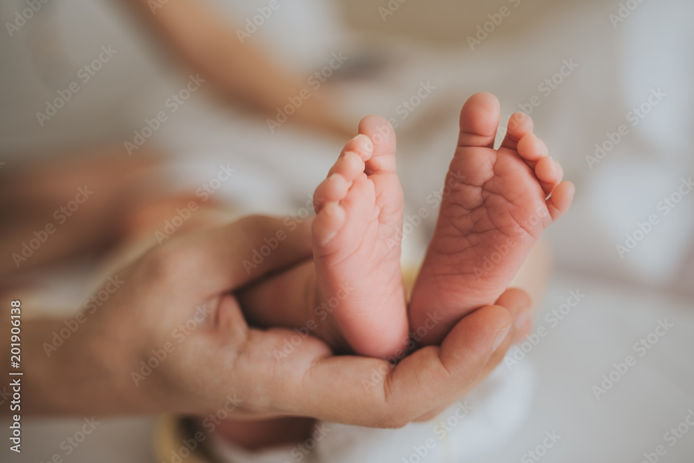 mother hold feets of newborn baby.Skin care concept mother hold feets of newborn baby.Skin care concept