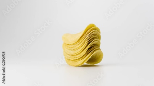 Preparation of chips on a white background. Manufacture of chips. Chips from potatoes. Snack. 4k. Stop Motion.