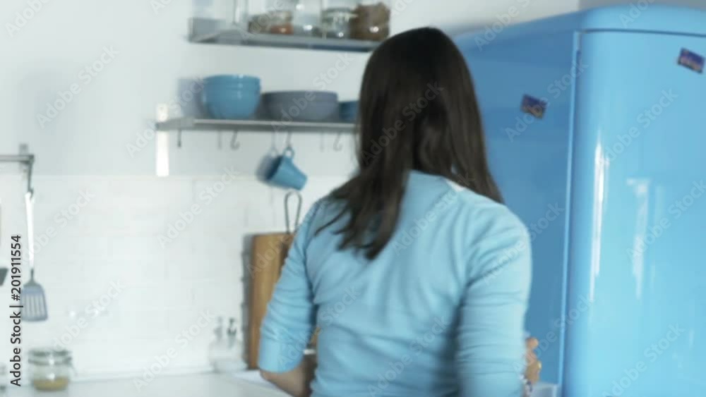 Young woman drinking water and leaving home
Young woman drinking water and leaving home