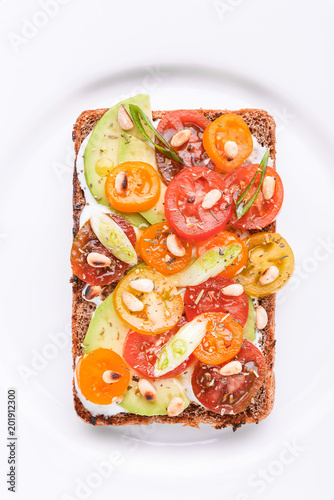 bruschetta with avocado, cherry tomatoes, blue cheese sauce, shallots. concept of a healthy breakfast