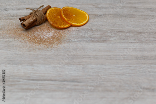 Fototapeta Naklejka Na Ścianę i Meble -  Cinnamon with orange slice on the wood texture background