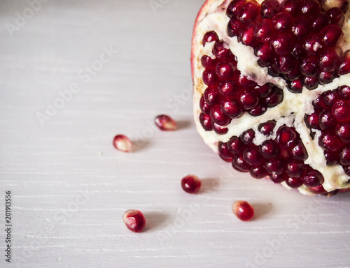 ripe pomegranate on a white table photo