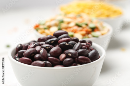 Fototapeta Naklejka Na Ścianę i Meble -  Different beans in bowls on a white wooden table