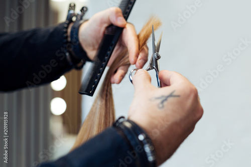 Hair stylist cutting woman's hair