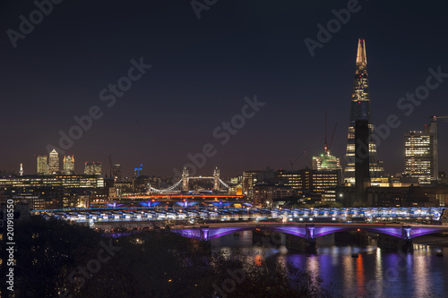 Beautiful landscape image of the London skyline at night looking along the River Thames