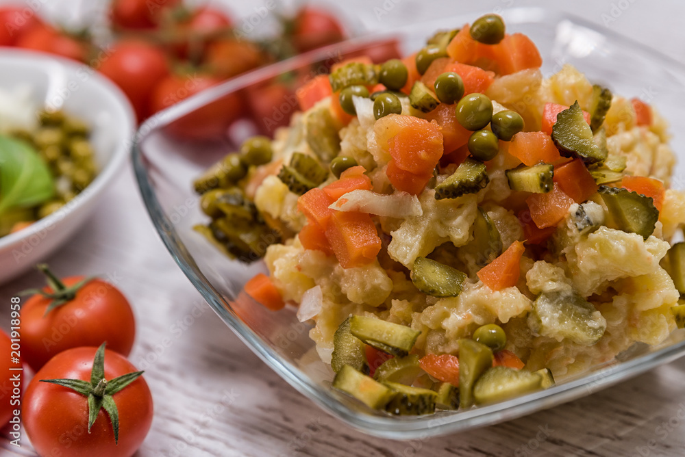 tasty potato salad in mycelium laid on the table, ingredients in lettuce - potatoes majneza carrot cucumbers traditional Slovak peas tasty potato salad in mycelium laid on the table, ingredients in lettuce - potatoes majneza carrot cucumbers traditional Slovak peas
