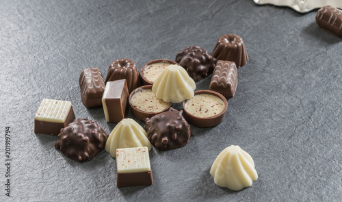 Chocolate sweets assortment on the grey textured background