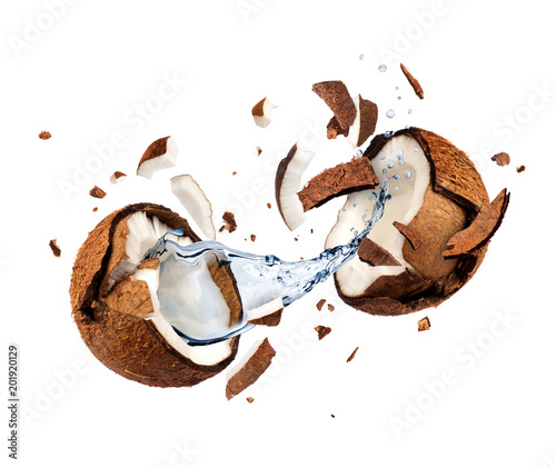 Coconut explodes into pieces on white background