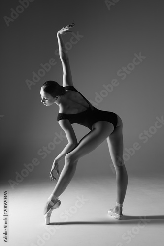 Fototapeta Naklejka Na Ścianę i Meble -  Young beautiful ballerina is posing in studio
