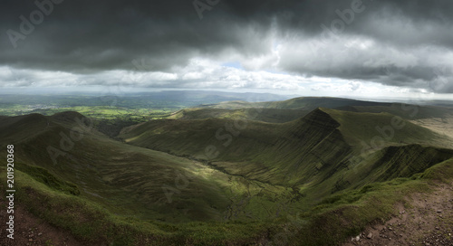 Landscape view from Pen y fan peak in Brecon Beacons with dark moody stormy sky