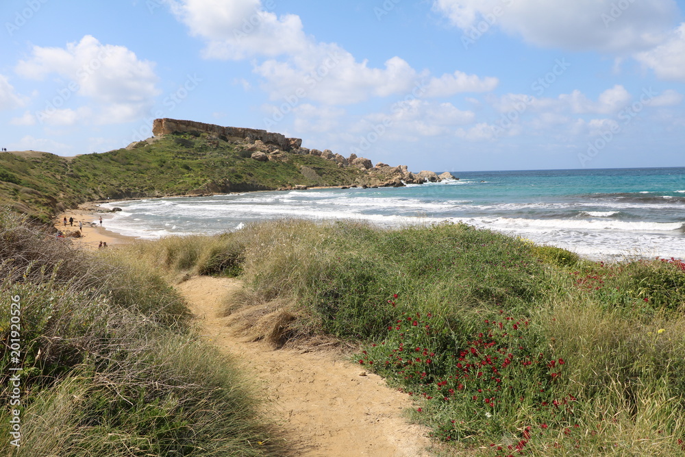 Hiking trail around Ghajn Tuffieha Bay at the Mediterranean sea in Malta 