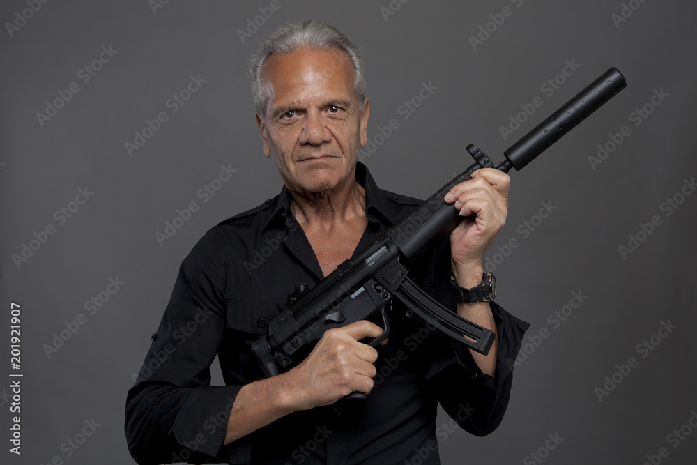 Fototapeta premium Senior hitman with automatic rifle