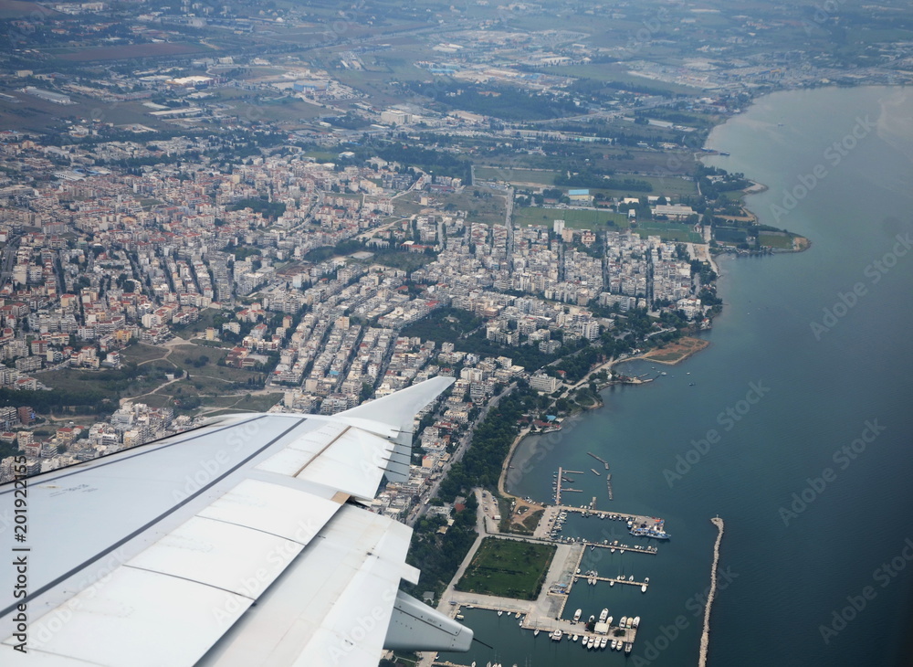 Fototapeta premium The Greek city of Thessaloniki from the airplane. You can see the silvery wing of the aircraft